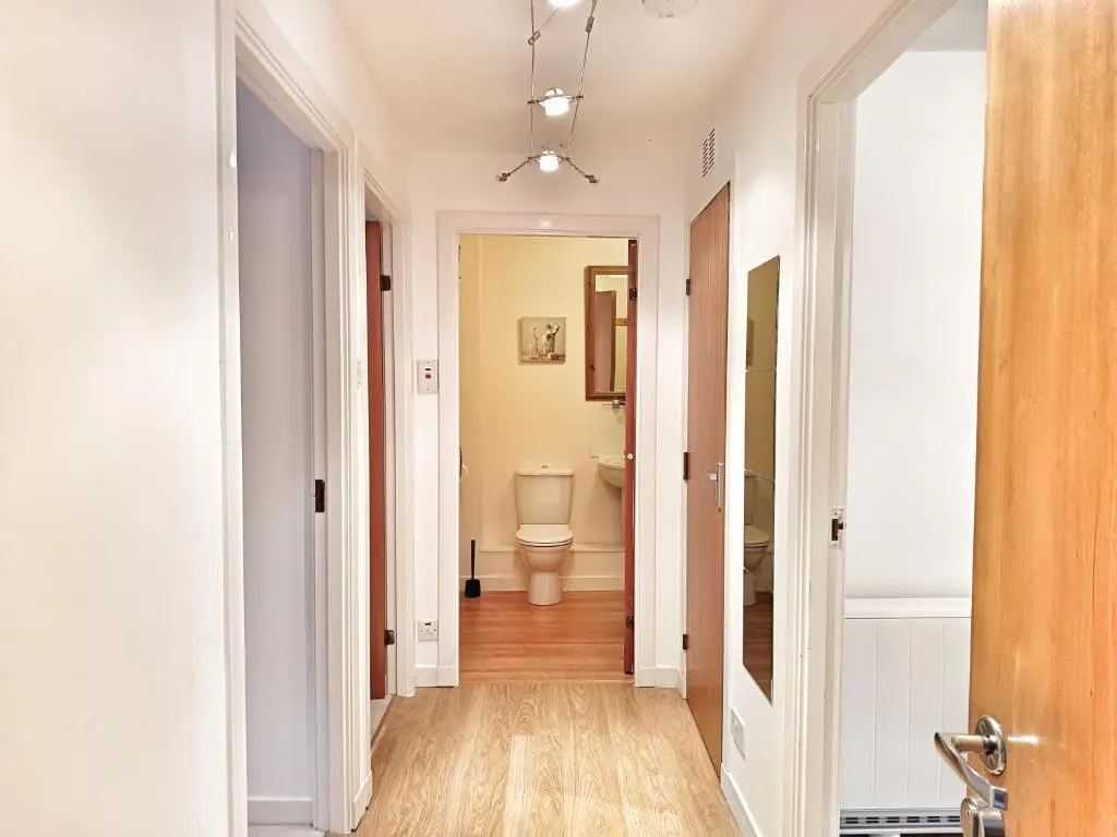 a corridor of a bathroom with a toilet at 2 Bed, Banchory in Banchory
