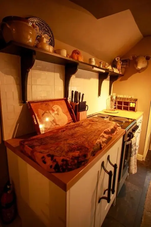 a kitchen with a counter top and a stove at Bliss Cottage in Nairn