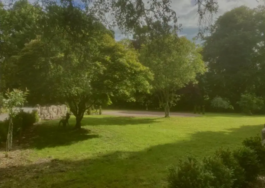 a park with trees and a grass field at Bliss Cottage in Nairn