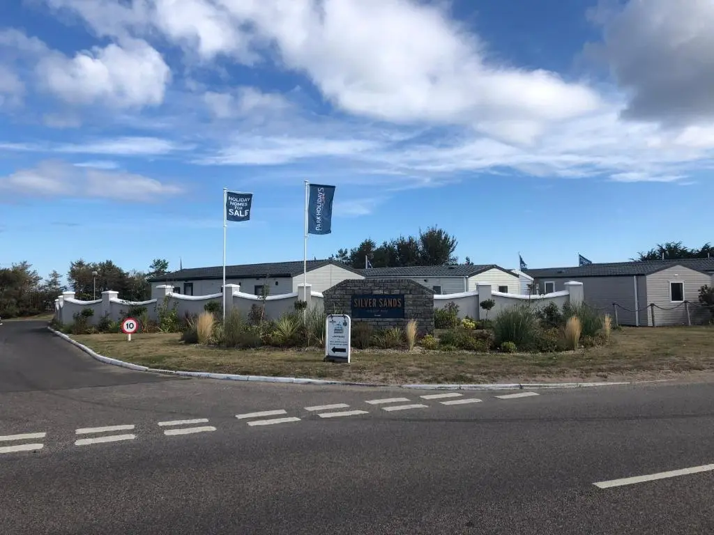 a street with two flags in front of houses at Dunes Escape in Lossiemouth