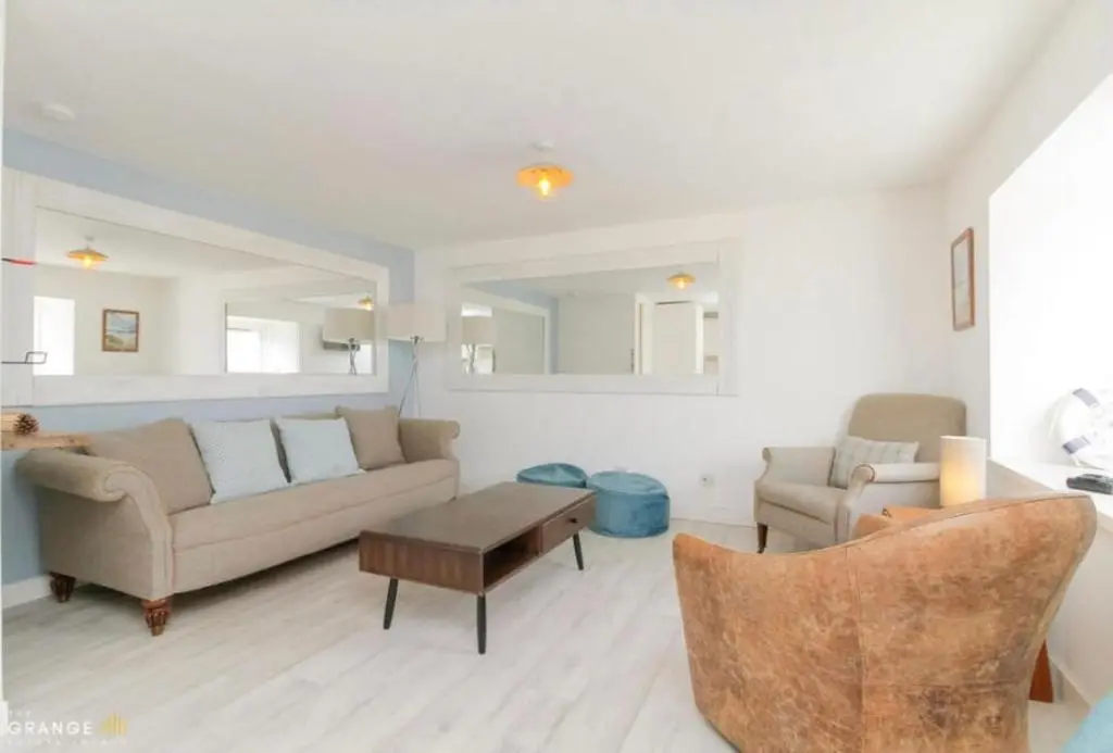 a living room with a couch and a table at The Beach Flat in Burghead