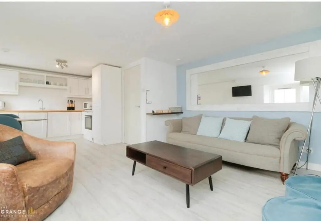 a living room with a couch and a coffee table at The Beach Flat in Burghead