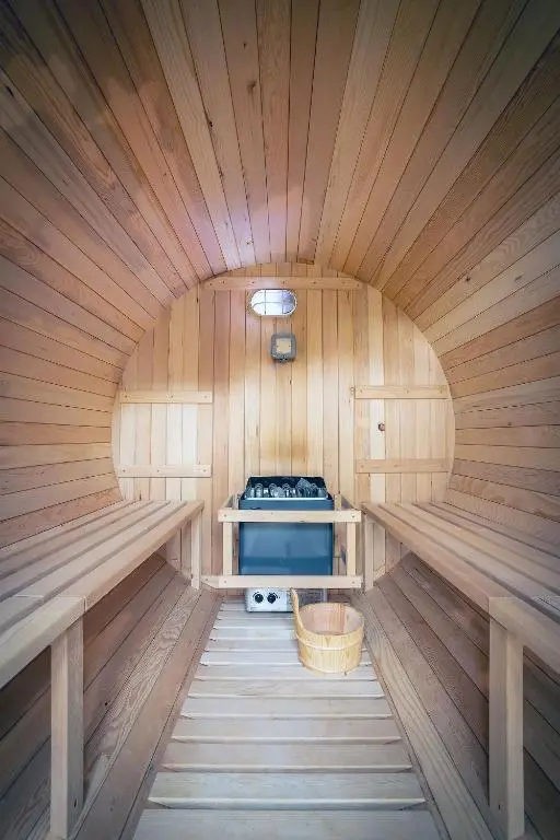 an inside of a sauna with a stove in it at Kirkstone Lodge in Insh