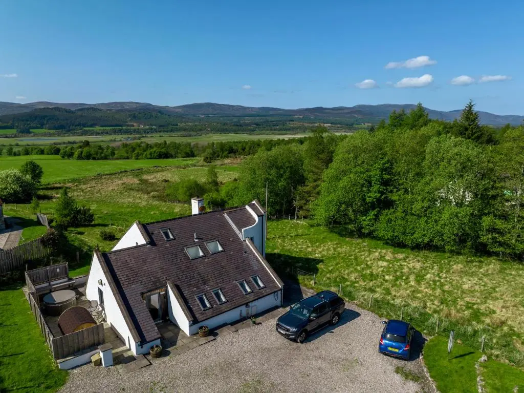 an aerial view of a house with two cars parked in front at Kirkstone Lodge in Insh