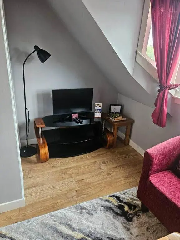 a living room with a couch and a table at Flat 3/2 Murray Place Haugh Rd Inverness IV2 4SH in Inverness