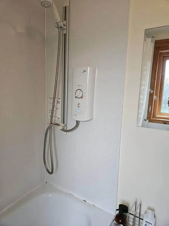 a shower in the corner of a bathroom at Harbour View 45 Anderson Street Inverness IV3 8BU in Inverness