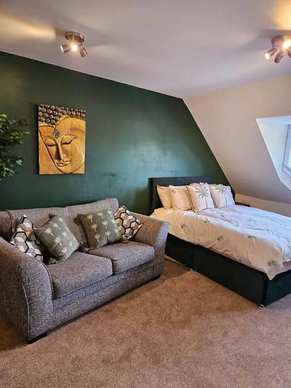 a bedroom with a bed and a couch in it at Flat 4 /2 Murray Place Haugh Rd Inverness IV2 4SH in Inverness