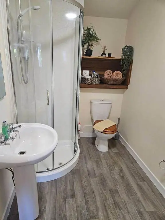 a bathroom with a shower and a sink and a toilet at Flat 4 /2 Murray Place Haugh Rd Inverness IV2 4SH in Inverness
