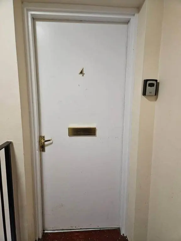 a white door with a gold handle in a room at Flat 4 /2 Murray Place Haugh Rd Inverness IV2 4SH in Inverness