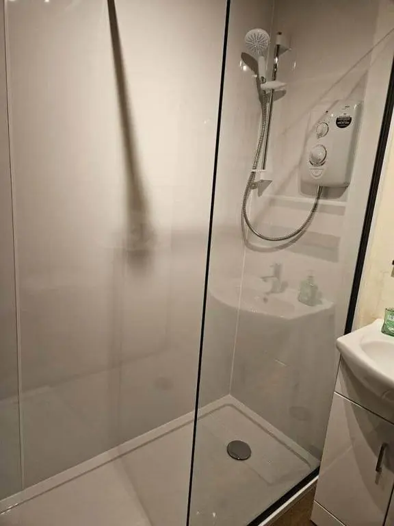 a bathroom with a shower and a sink at 8 Ardross Court 20 Ardross St. Inverness IV3 5NH in Inverness