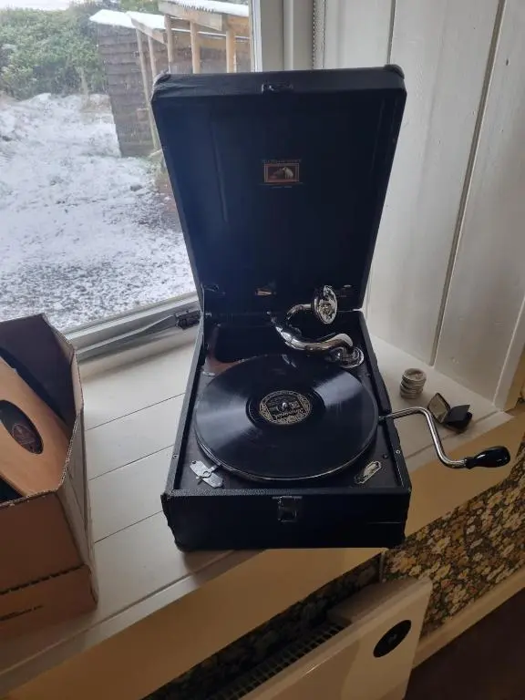 a black record player sitting on a counter next to a window at bochruben in Inverness