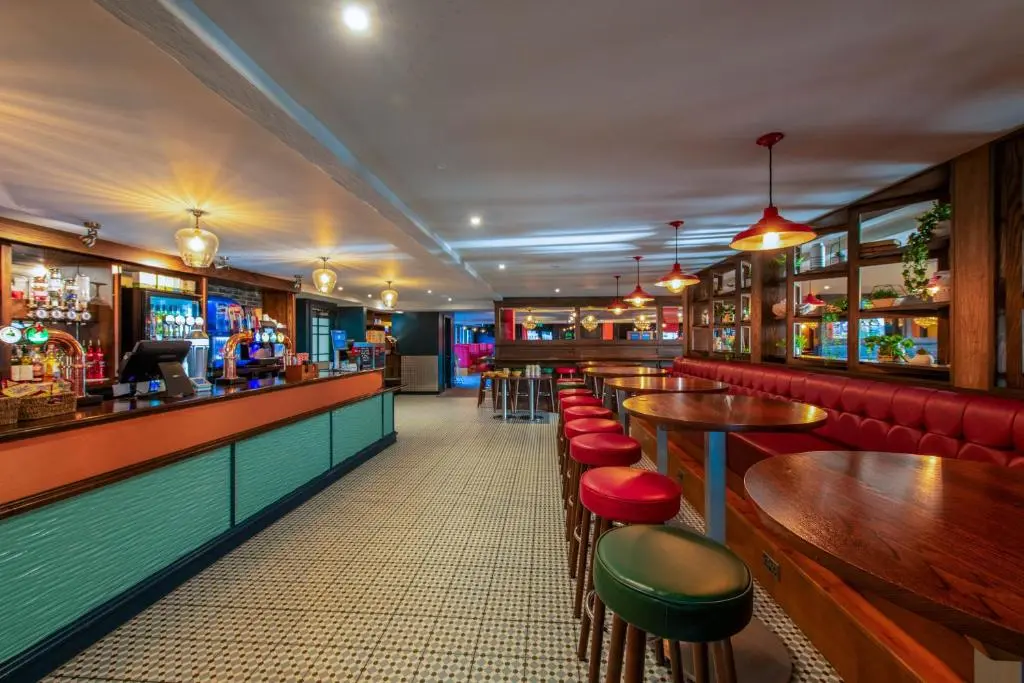 a bar with tables and stools in a restaurant at B17 SilverSands Escape in Lossiemouth