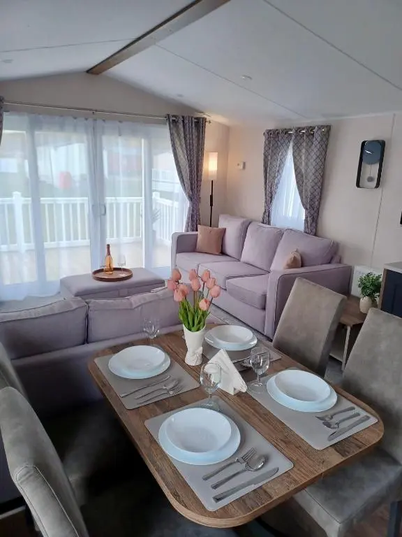 a living room with a table and a couch at B17 SilverSands Escape in Lossiemouth