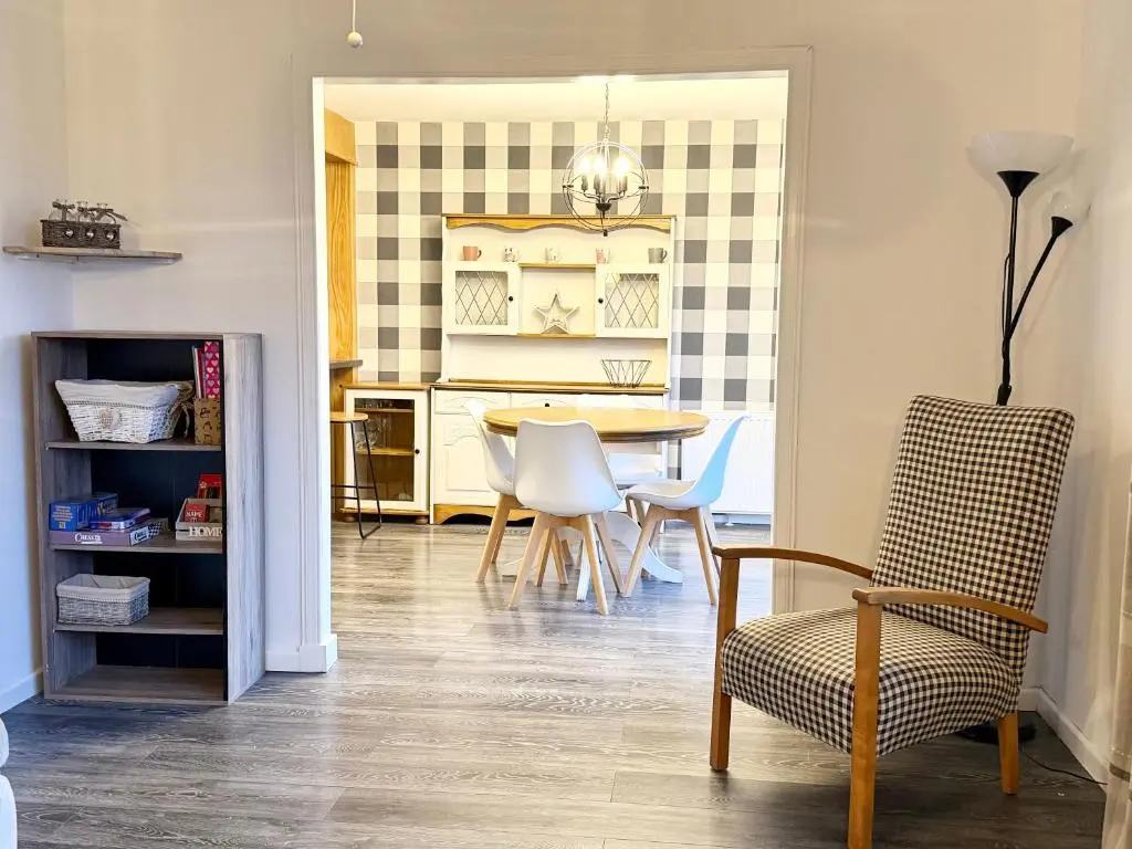 a dining room with a table and chairs at Mamore House Inverness in Dalneigh