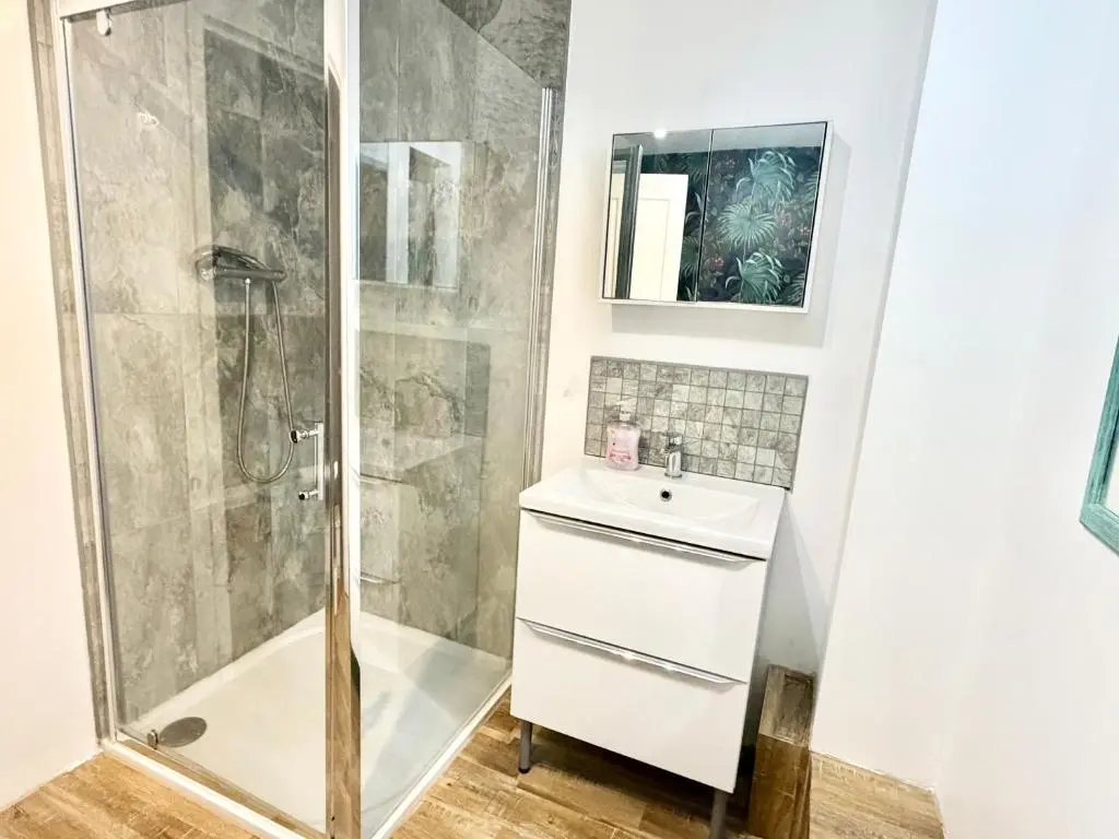 a bathroom with a shower and a sink at Mamore House Inverness in Dalneigh