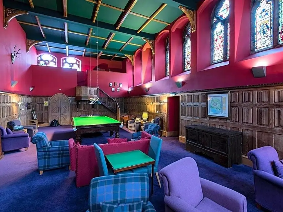a room with ping pong tables and purple chairs at Entirely New Monastery Renovation on Loch Ness in Fort Augustus