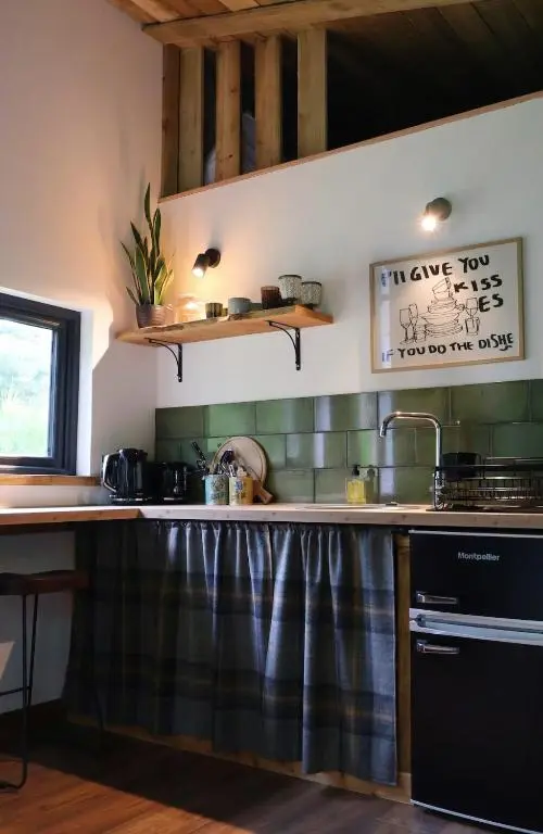 a kitchen with a sink and a counter top at Bespoke Wood Cabin - Loch Ness in Inverfarigaig