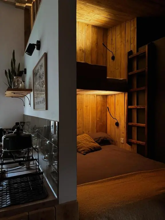 a bedroom with a bunk bed with wooden walls at Bespoke Wood Cabin - Loch Ness in Inverfarigaig