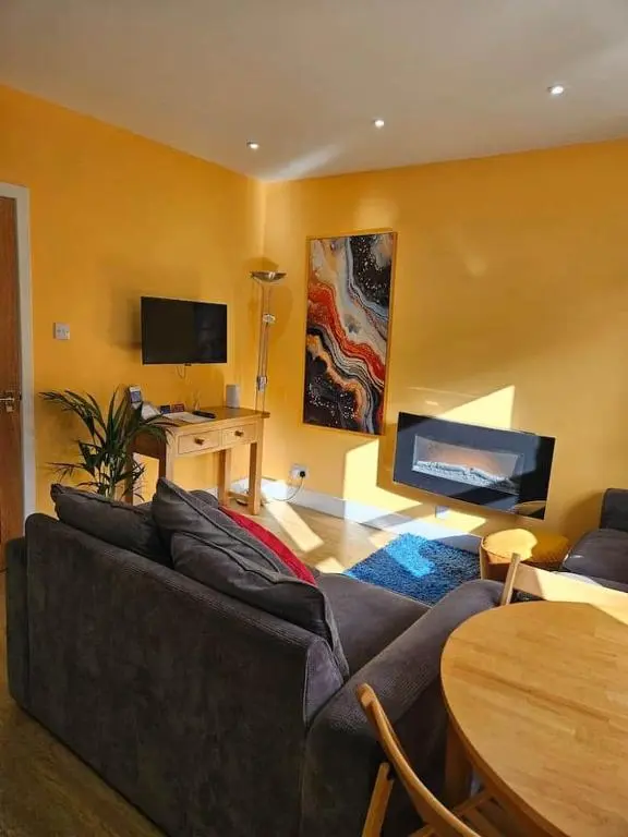 a living room with a couch and a table at City center apartment in Inverness