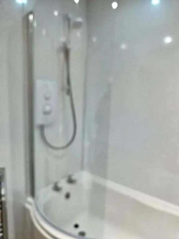 a bathroom with a shower and a sink at City center apartment in Inverness