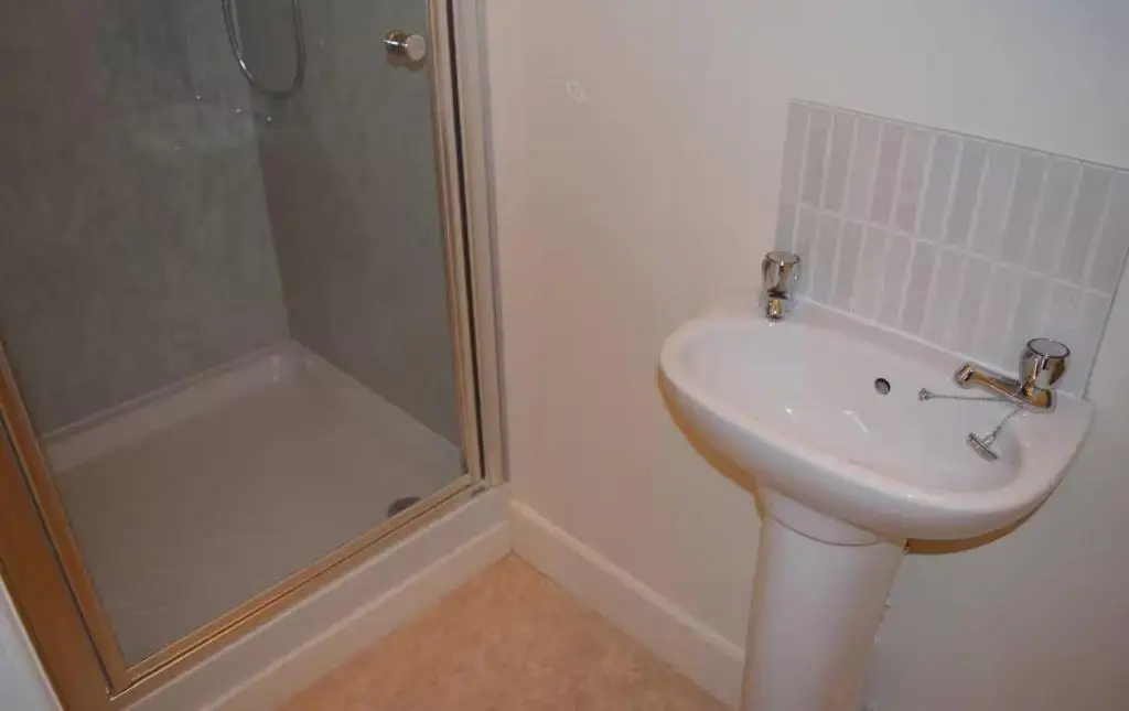 a white bathroom with a shower and a sink at Bankside - 1 En-Suite in Central - Free Parking in Wick