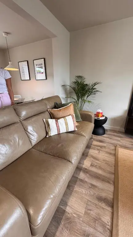 a brown leather couch in a living room at No 67 West Road in Fraserburgh