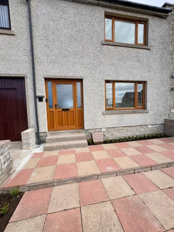 a house with a brown door and a patio at No 67 West Road in Fraserburgh