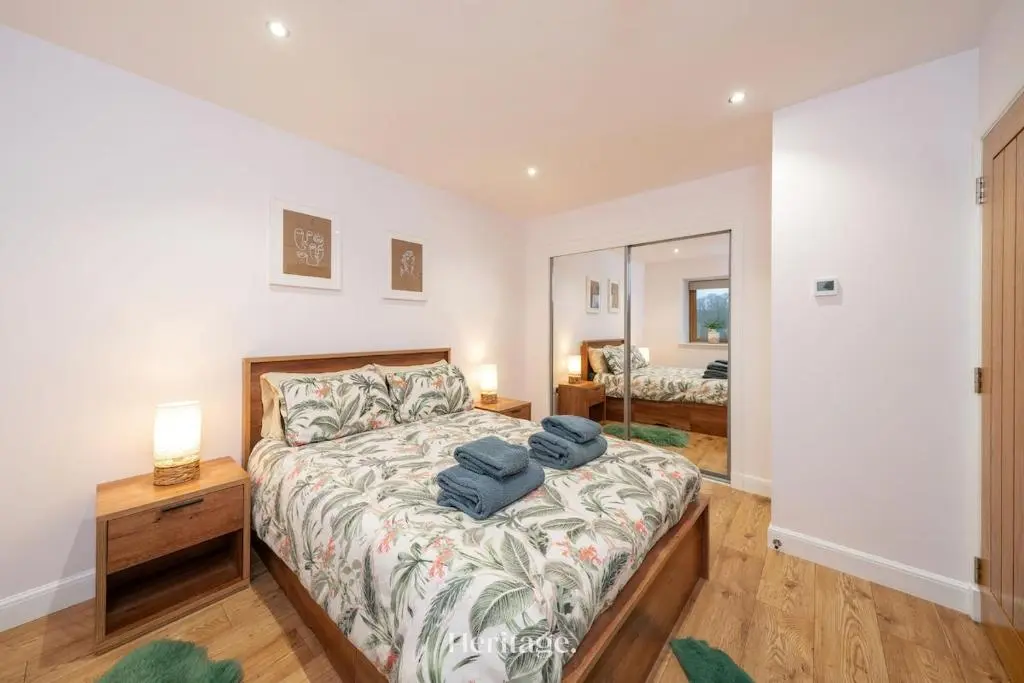 a bedroom with a bed with two blue towels on it at The Steading Family Friendly Getaway in Peterhead