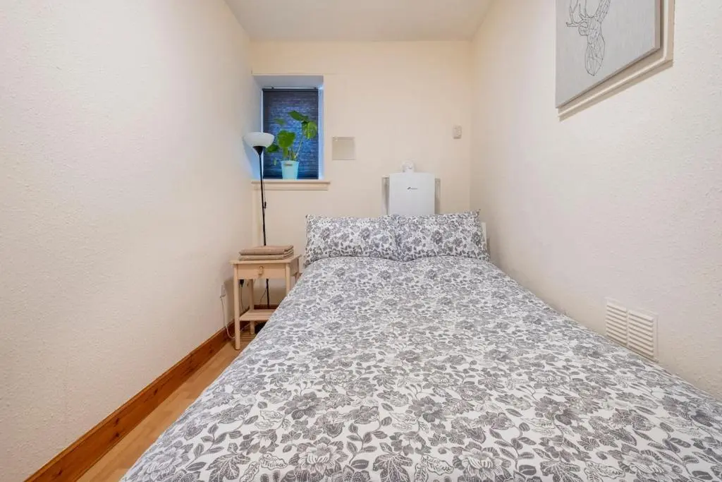 a bedroom with a bed in a room at 2 Bed Central Apart - May Court in Inverness