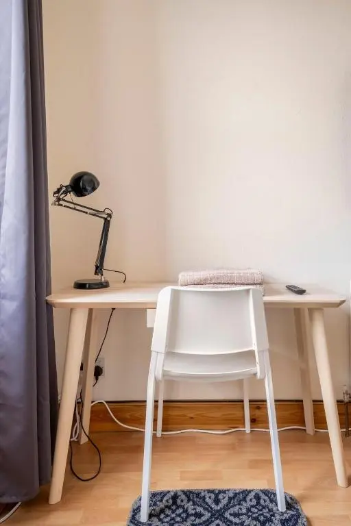 a desk with a white chair and a lamp at 2 Bed Central Apart - May Court in Inverness