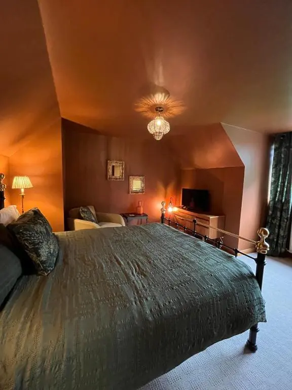 a bedroom with a large bed in a room at Freeburn Lodge - Tomatin in Tomatin