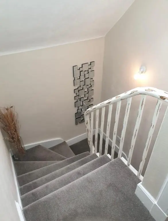a staircase in a home with a white stair case at Buckie Central 2 Bed Retreat in Buckie