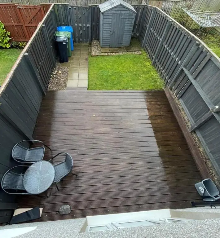 a wooden walkway with two benches and a fence at Skibo Place House in Inshes