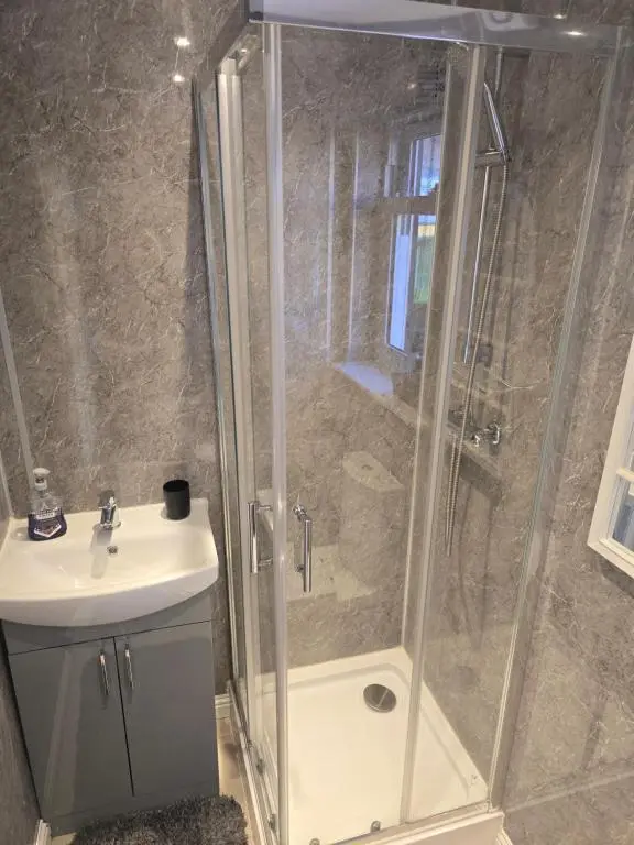 a bathroom with a shower and a sink at Nanny bambi's three bedroom's in Inverness