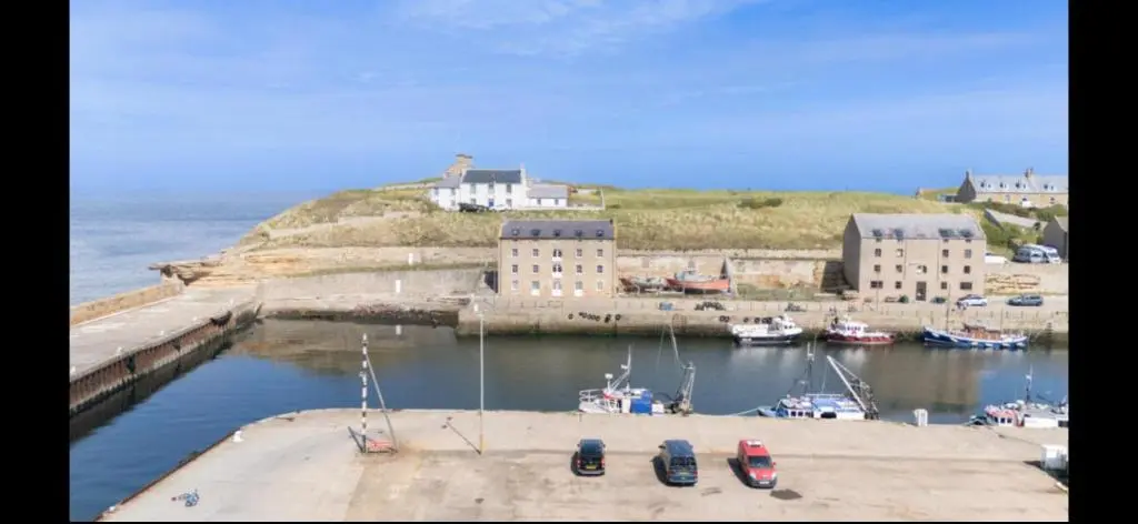 a group of boats are docked in a harbor at Harbour Haven in Burghead