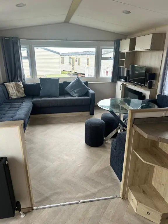 a living room with a couch and a table at Moonstone in Lossiemouth