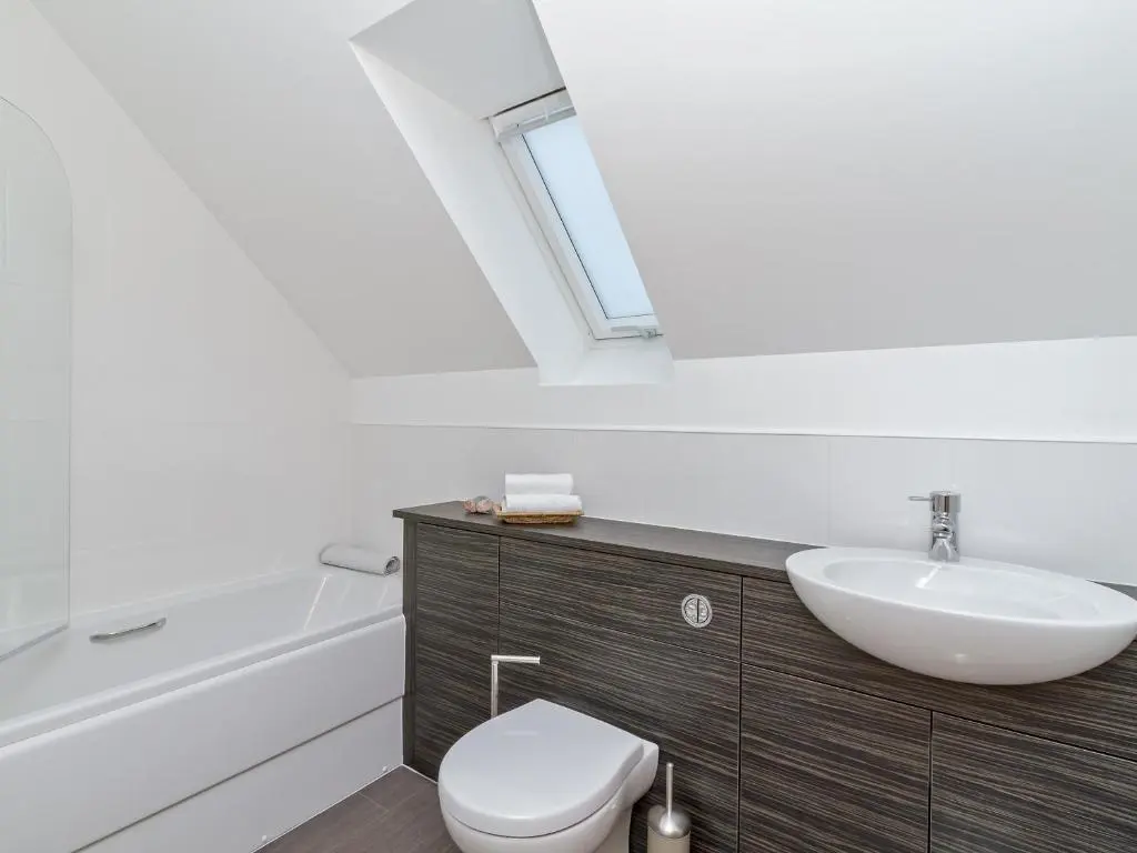 a bathroom with a sink and a toilet and a mirror at Birch Corner in Aviemore