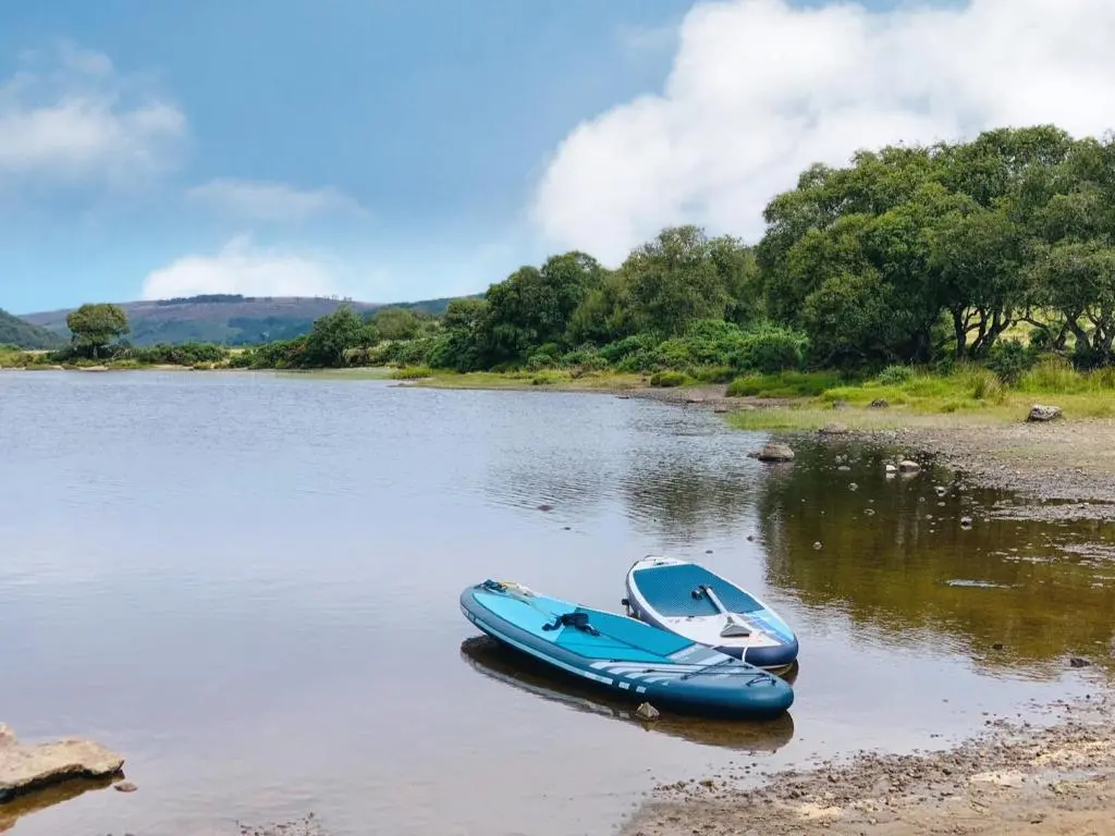 a blue boat is sitting in the water at Drummuie House in Golspie