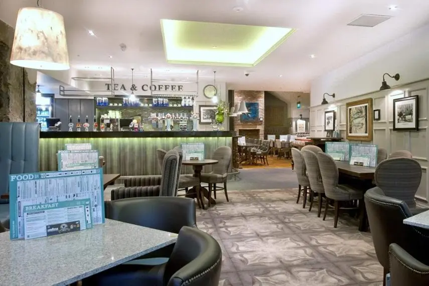 a restaurant with tables and chairs and a bar at The Saltoun Inn in Fraserburgh