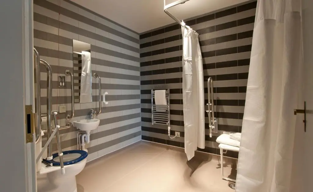 a bathroom with a black and white striped wall at The Saltoun Inn in Fraserburgh