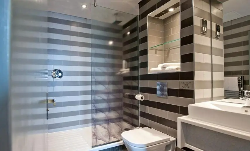 a bathroom with a shower and a toilet and a sink at The Saltoun Inn in Fraserburgh