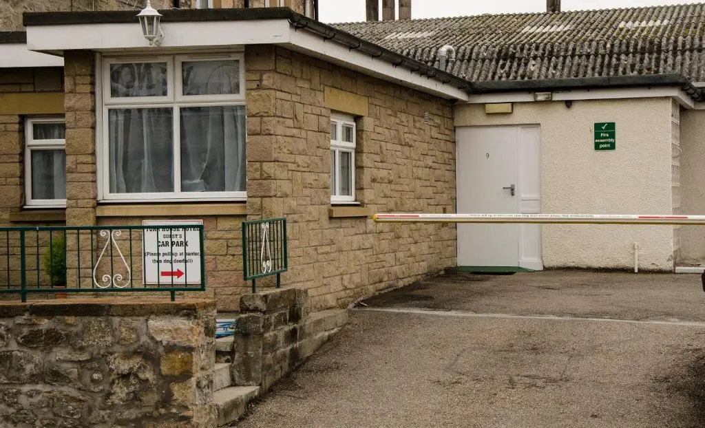a brick house with a white door and a driveway at Elgin City Centre Torr House hotel in Elgin