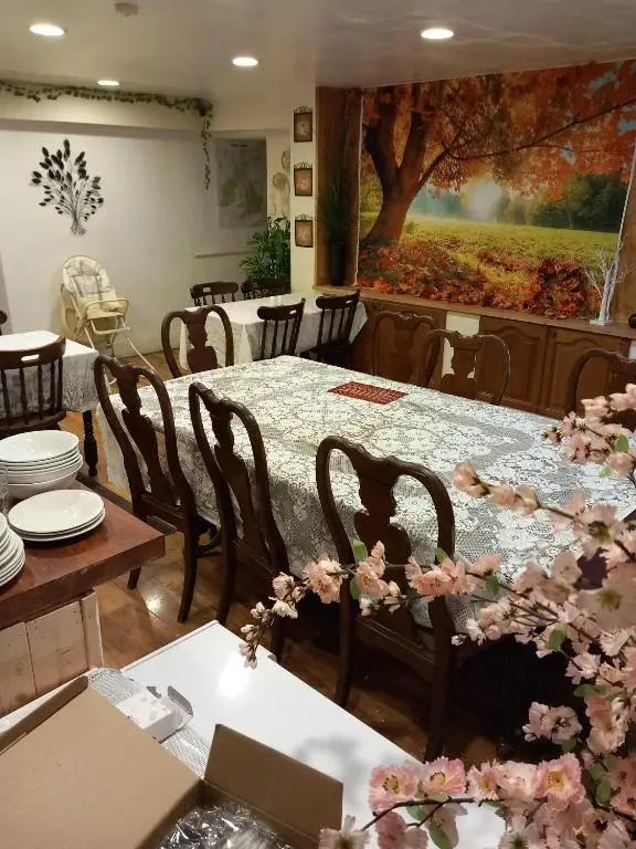 a dining room with a table with flowers on it at Aberdeen Arms Hotel Tarland in Tarland