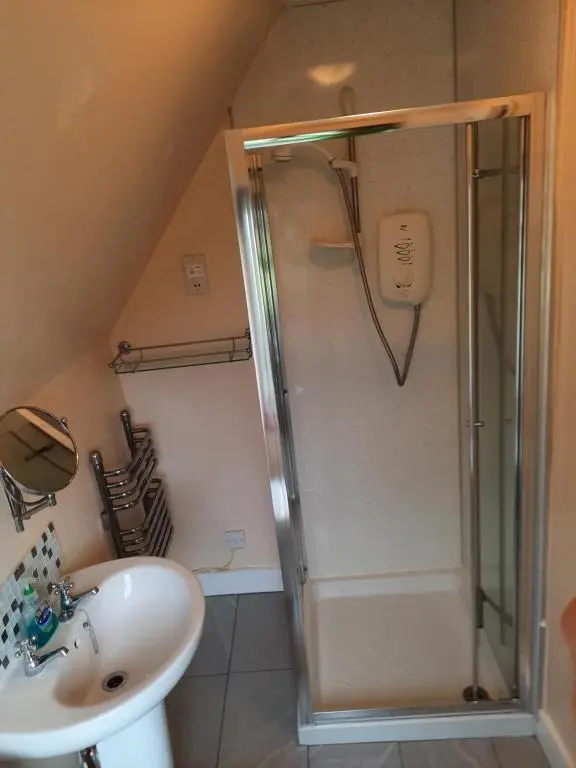 a bathroom with a shower and a sink at Jacobite Rose in Inverness
