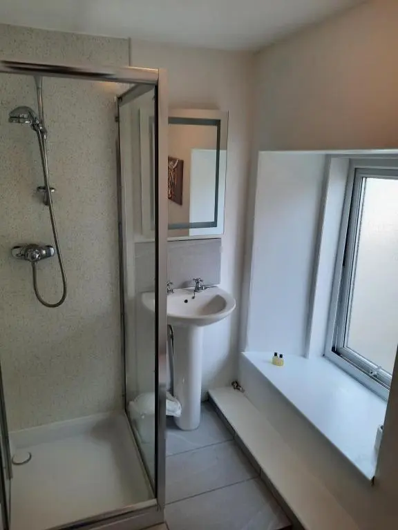 a bathroom with a shower and a sink at Jacobite Rose in Inverness