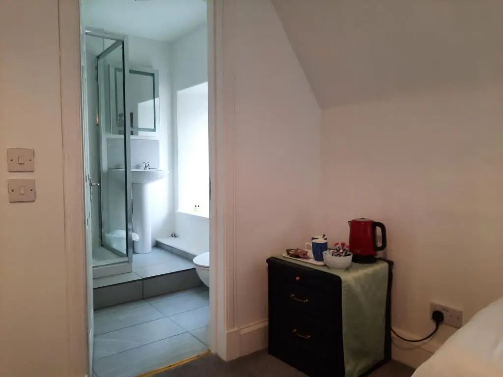 a bathroom with a toilet and a sink and a mirror at Jacobite Rose in Inverness