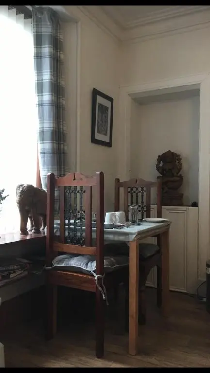 a dining room table with two chairs and a table and a table and chairsuggest at Jacobite Rose in Inverness