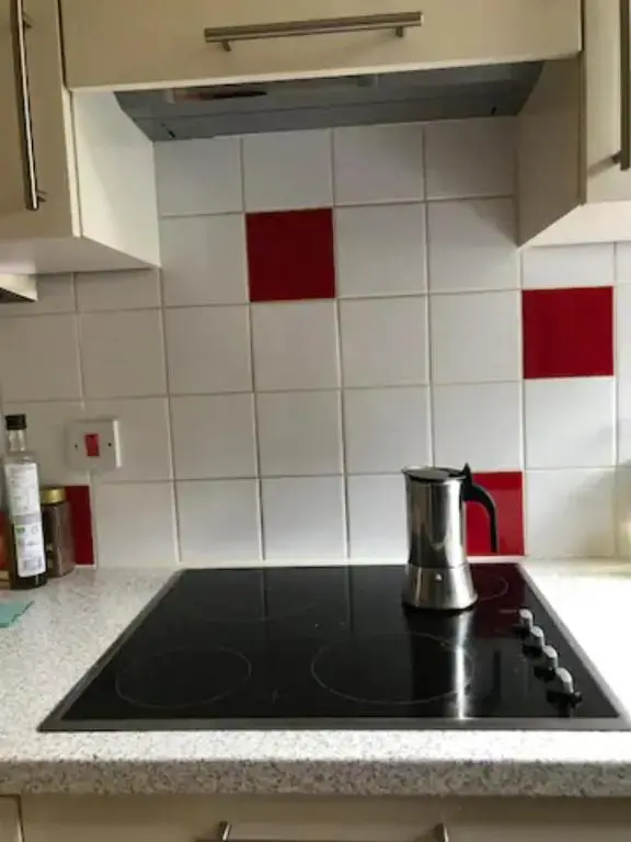 a tea kettle sitting on top of a stove in a kitchen at Home Comforts in Peaceful 2 Acres in Inverness