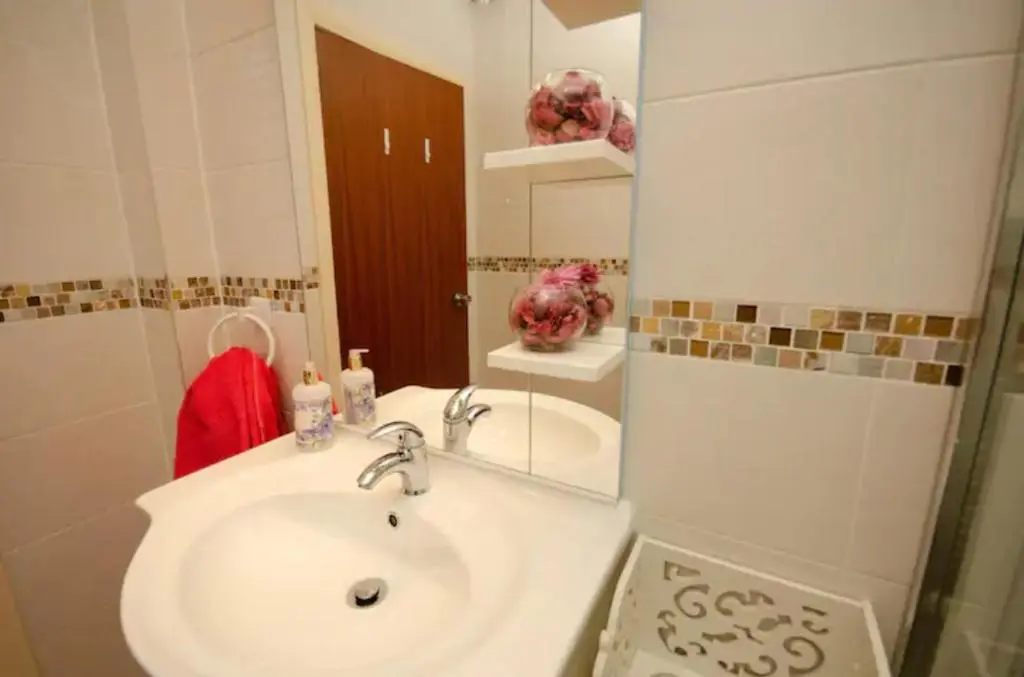 a bathroom with a sink and a mirror at Home Comforts in Peaceful 2 Acres in Inverness