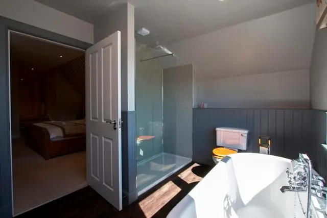 a bathroom with a glass shower and a tub at Glen Clova Hotel & Luxury Lodges in Millton of Clova